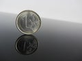 Single Euro coins on grey background Royalty Free Stock Photo