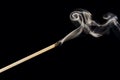 A single extinguished match with smoke rising up, isolated on a black background Royalty Free Stock Photo