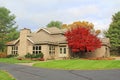 Single Family Brick Contemporary Home with Fall Leaves. Royalty Free Stock Photo