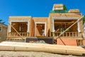 New family home under construction with stacks of 2x4 timber boards on the top Royalty Free Stock Photo