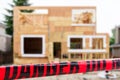 Single family home under construction with red warning ribbon reading danger do not cross Royalty Free Stock Photo