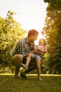 Single father playing in the meadow with daughter. Royalty Free Stock Photo