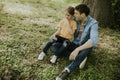 Single father sitting on grass by the tree with little daughter Royalty Free Stock Photo