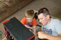 Single Father and Son Fixing Computer Royalty Free Stock Photo