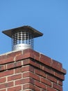 Single Flue Chimney Cap Close up Atop a Red Brick Chimney