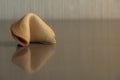 Single Fortune Cookie Reflects In Glossy Surface With Copy Space