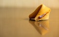 Single Fortune Cookie Reflects In Glossy Table Top