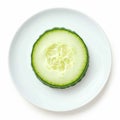 Single fresh cucumber slice on white plate, isolated view Royalty Free Stock Photo