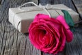 Single fresh pink rose symbolic of love and romance on a rustic wooden table for a sweetheart on Valentines Day, Mothers Day or an