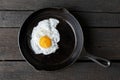 Single fried egg in cast iron frying pan sprinkled with ground b Royalty Free Stock Photo