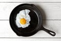 Single fried egg in cast iron frying pan sprinkled with ground b Royalty Free Stock Photo