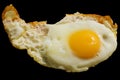 Single fried egg isolated on black background Royalty Free Stock Photo