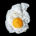 Single fried egg sprinkled with ground black pepper isolated on Royalty Free Stock Photo