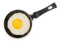 Single fried egg in very small pan with non-stick surface isolated on white background, top view Royalty Free Stock Photo