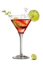 A single glass filled with a Cosmopolitan cocktail and garnished with a lime slice, isolated on a white background Royalty Free Stock Photo