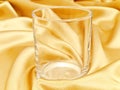 Single glass at golden background