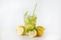 Single glass of iced lemonade. Studio shot of refreshing non alcoholic mojito drink with lemon slices, mint leaves and ice Royalty Free Stock Photo