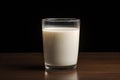 Single glass of milk on dark background