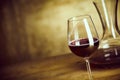 Single glass of red wine alongside a decanter Royalty Free Stock Photo