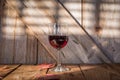 Single glass of red wine on wood table Royalty Free Stock Photo