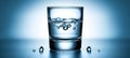 Single Glass of Water with Rising Bubbles on a Gradient Blue Background with Copy Space Royalty Free Stock Photo