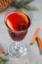 Single glass with winter Christmas traditional mulled wine with orange slices, anise and cinnamon sticks Royalty Free Stock Photo