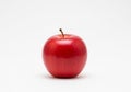 A single, glossy red apple sits centered against a plain white backgroun Royalty Free Stock Photo