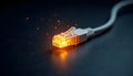 A single, glowing Ethernet cable plug illuminates the inky darkness of a cold, metallic surface. Royalty Free Stock Photo