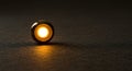 Single glowing orb casting warm light on black Royalty Free Stock Photo