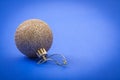 Single gold colored christmas ball on blue background