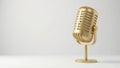 A single gold microphone against a plain white backdrop , golden, detail Royalty Free Stock Photo