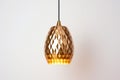 single gold pendant lamp against a white ceiling