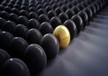 Single golden Egg in a  large Group of black Eggs Royalty Free Stock Photo