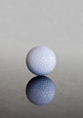 Single golf ball reflection Royalty Free Stock Photo