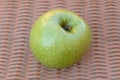 Single Granny Smith apple isolated on brown background Royalty Free Stock Photo