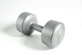 A single gray dumbbell with round weights and a cylindrical handle Royalty Free Stock Photo