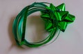 A single green present bow and looped ribbon isolated on a white background Royalty Free Stock Photo