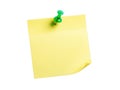 Single green pushpin securing yellow note Royalty Free Stock Photo