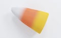 Single Halloween Candy Corn on a white background. Traditionally given out as a treat on Halloween for minimal idea creative