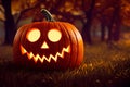 Single halloween Jack-o`-lantern pumpkin with a scary triangular face carved in, standing on the grass, being illuminated by candl