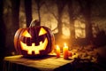 Single halloween Jack-o`-lantern pumpkin with a scary triangular face carved in, standing on a old wood being illuminated by candl