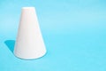 single hand-crafted paper frustum cone on blue Royalty Free Stock Photo