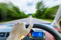 Single hand holding right steering wheel driving on motion road Royalty Free Stock Photo