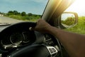 Single hand of man driving car.