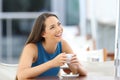 Woman daydreaming in a coffee shop