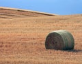 Single Hay Bale in a Field under a Blue Sky Royalty Free Stock Photo