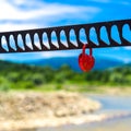 A single heart shaped red padlock symbolizing love