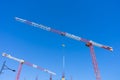Single high-rise construction crane on the blue sky background.