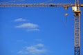 Single high-rise construction crane on the blue sky background