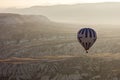 Single Hot air balloons in the sky during sunrise. Flying over colourful rock formations in Cappadocia, Turkey in Goreme Royalty Free Stock Photo